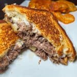 Short Rib Grilled Cheese - Grilled brie cheese with short rib, peach pepper jam, and caramelized onions