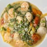 Sauteed shrimp and day boat scallops on a bed of fresh linguini in rustic scampi broth with tri-colored tomatoes & arugula