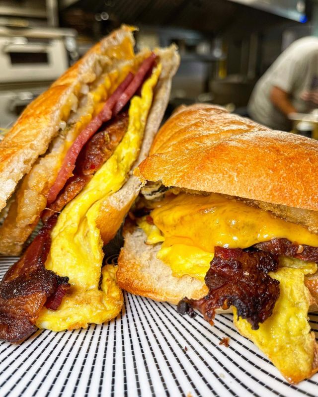 Do not miss out on our Farmhouse Handheld for brunch. It has everything you could want for breakfast in one sandwich - scrambled eggs, American cheese, pork roll, breakfast sausage, bacon on ciabatta served with breakfast potatoes!